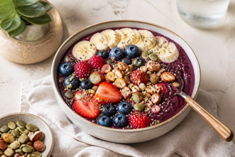 Protein-packed acai bowl with berries, banana, nuts, and seeds